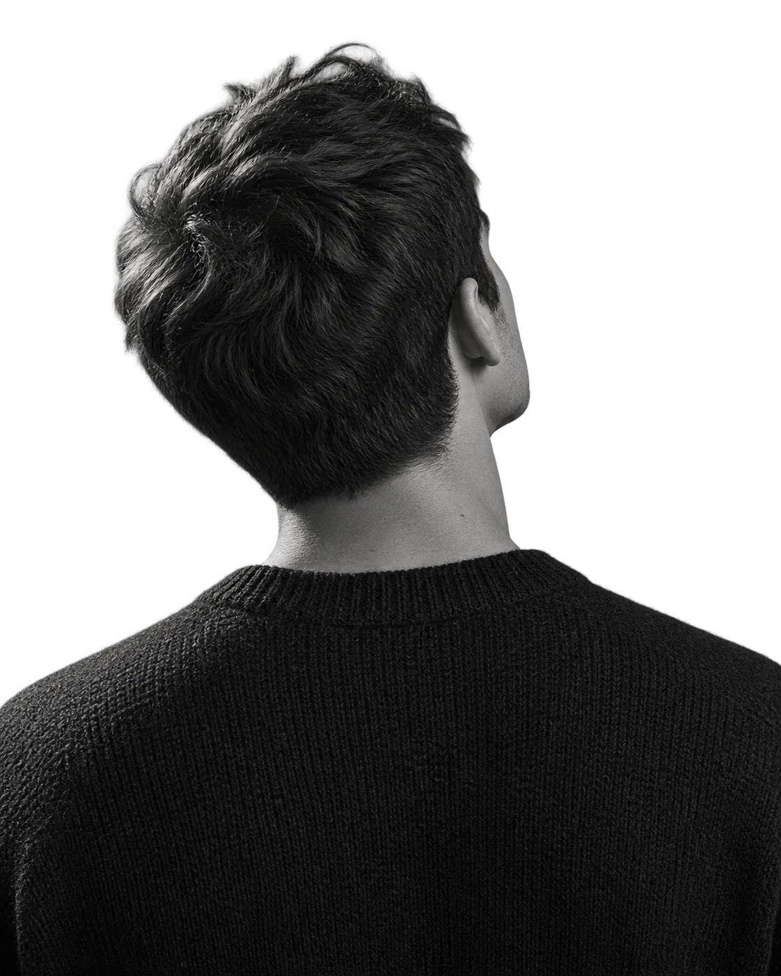 A person seen from behind, looking up at the cards circling them